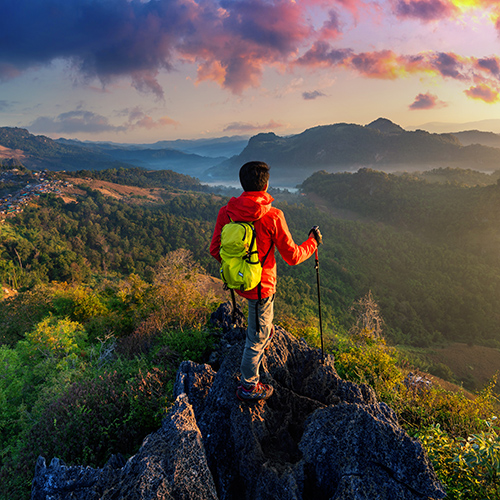 A man standing on top of the mountain