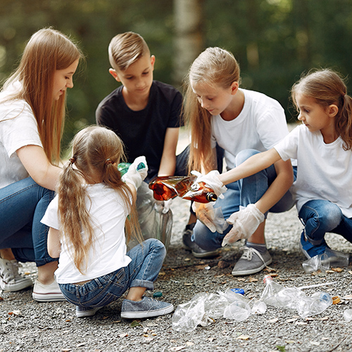 image of a group of kids collecting plastic bottles