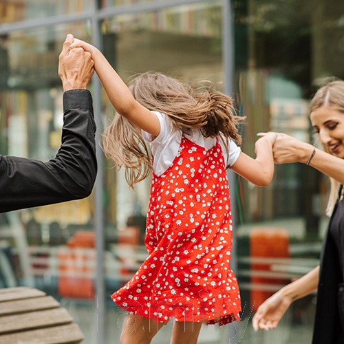 image of parent holding hands with a girl